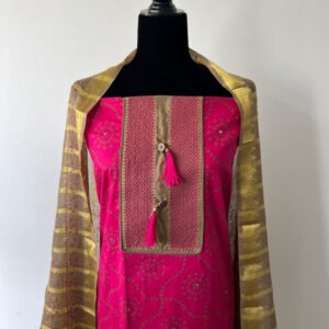 Bright pink unstitched material with gold and pink embroidered front panel, styled with a sheer golden yellow dupatta.