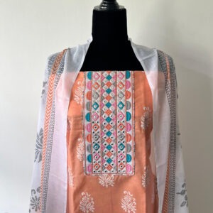 Peach unstitched top with multicolour geometric embroidery on the front panel, displayed on a black mannequin, paired with a white printed dupatta featuring grey and orange details.