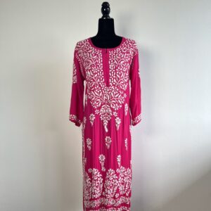 Black half-body mannequin displaying a bright pink chikankari kurti with intricate white embroidery, three-quarter sleeves, and a flowing design.
