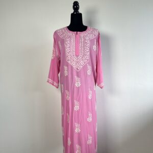 Black half-body mannequin displaying a soft pink chikankari kurti with intricate white embroidery, three-quarter sleeves, and a flowing design.