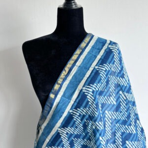 Blue tie-dye dupatta with white zig-zag design, displayed on a black mannequin bust, showing border with gold detail.