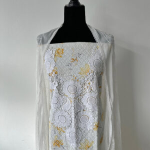 White unstitched 3-piece set displayed on a black mannequin, featuring mustard floral threadwork on the top and soft embroidered dupatta.