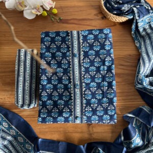Top material folded on wooden surface with floral print and wooden buttons