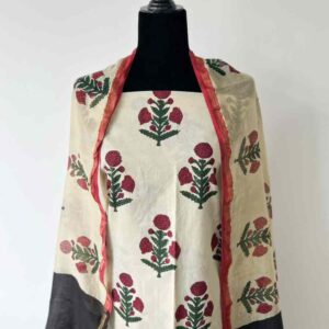 Cream unstitched set with maroon floral print displayed on mannequin with black dupatta.
