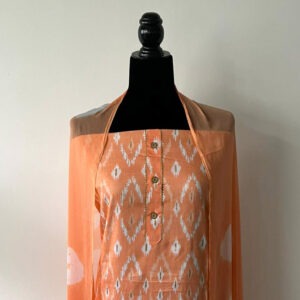 Peach unstitched set with printed design and chiffon dupatta displayed on mannequin.